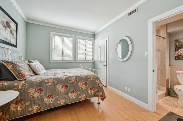 bedroom with baseboards, visible vents, crown molding, and wood finished floors