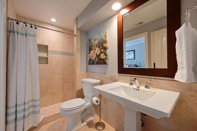 full bath featuring tile walls, recessed lighting, visible vents, toilet, and a tile shower