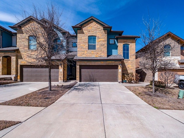 view of front of property with a garage, stone siding, and driveway