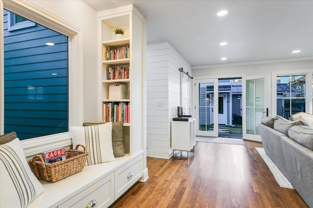 mudroom with dark wood-style floors, a barn door, and recessed lighting