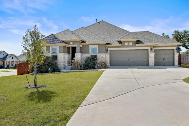 view of front of house with concrete driveway, fence, a front lawn, and an attached garage