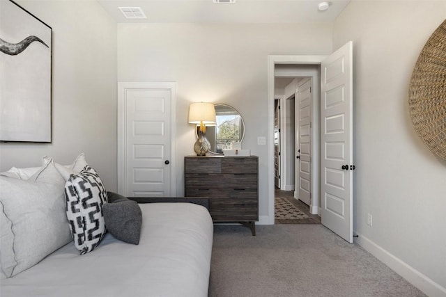 carpeted bedroom featuring visible vents and baseboards