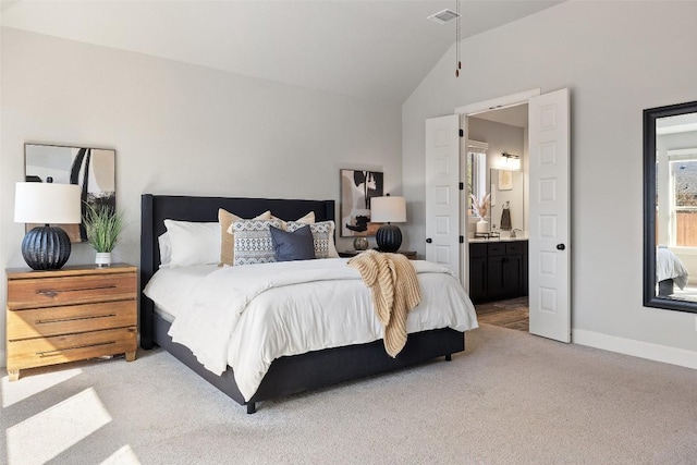 bedroom with connected bathroom, light carpet, visible vents, baseboards, and vaulted ceiling