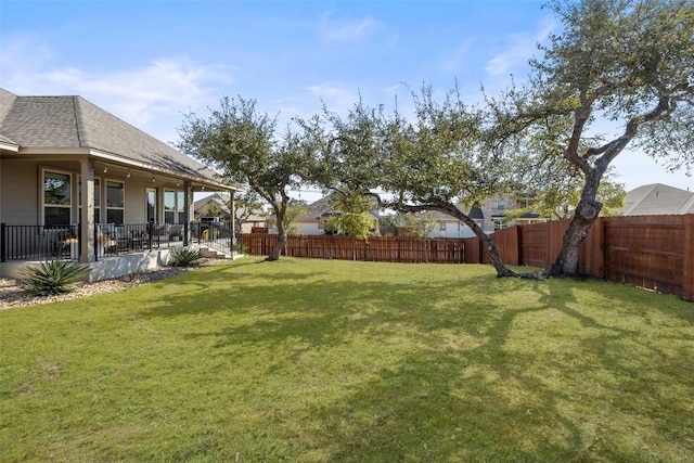 view of yard with a fenced backyard