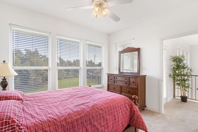 bedroom featuring baseboards, ceiling fan, and light colored carpet