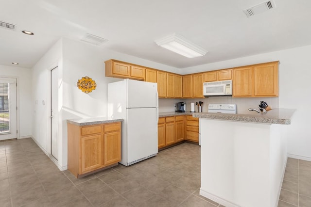 kitchen featuring a peninsula, white appliances, light countertops, and visible vents