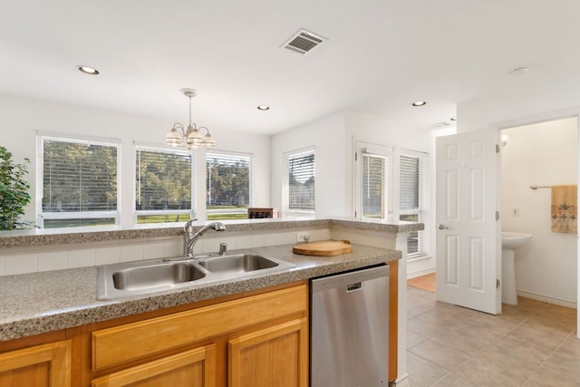 kitchen featuring light tile patterned floors, a sink, visible vents, stainless steel dishwasher, and decorative light fixtures