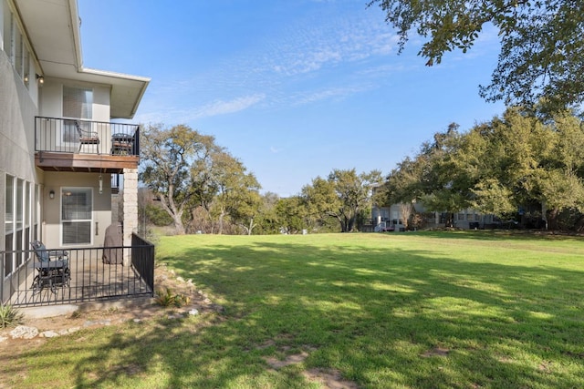 view of yard featuring a balcony and a patio area