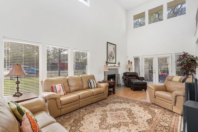 living area featuring a lit fireplace and wood finished floors