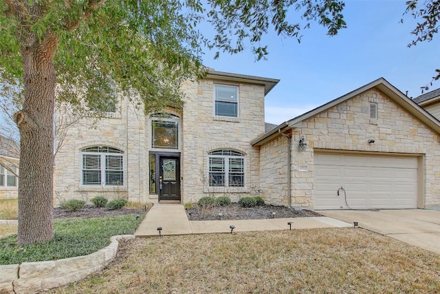 view of front of property featuring a garage, stone siding, and concrete driveway