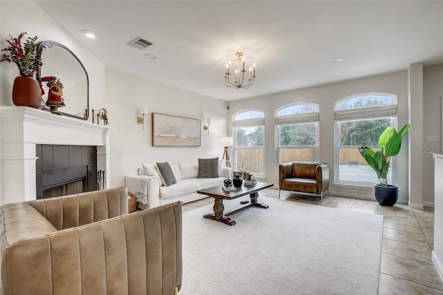 living room featuring a fireplace, recessed lighting, visible vents, a chandelier, and tile patterned floors