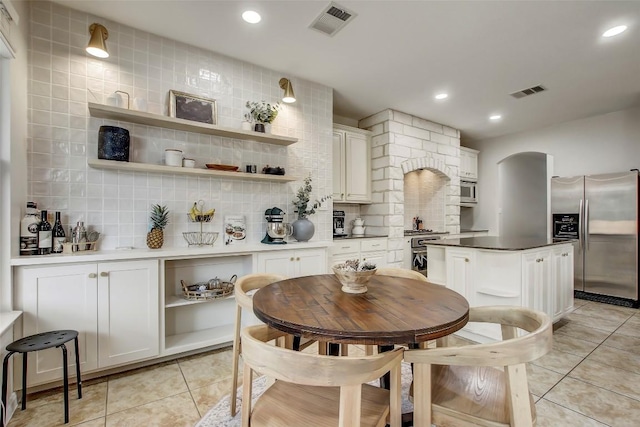 dining area with light tile patterned flooring, visible vents, and recessed lighting