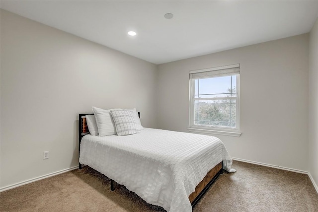 carpeted bedroom featuring baseboards and recessed lighting