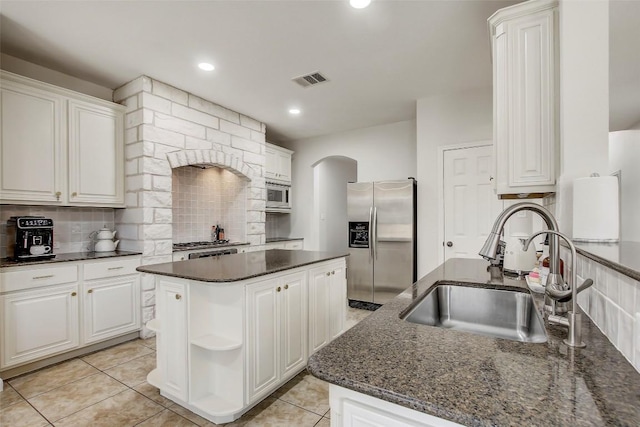 18712 Deep Water Dr, Pflugerville, TX 78660 - kitchen featuring stainless steel appliances, a sink, decorative backsplash, open shelves, and white cabinets