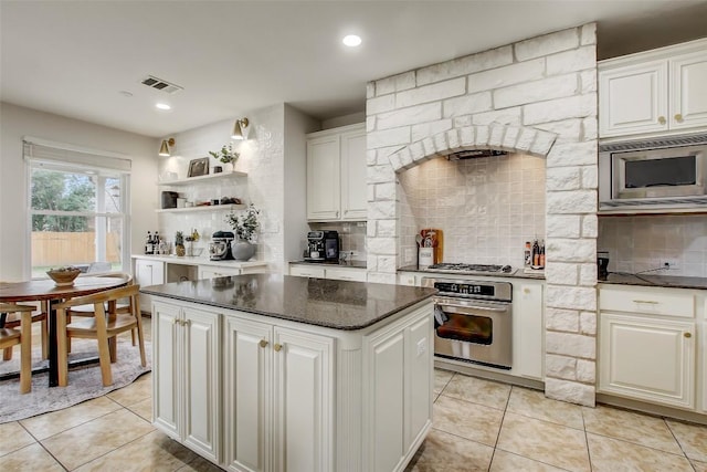 kitchen with light tile patterned flooring, stainless steel appliances, visible vents, backsplash, and open shelves