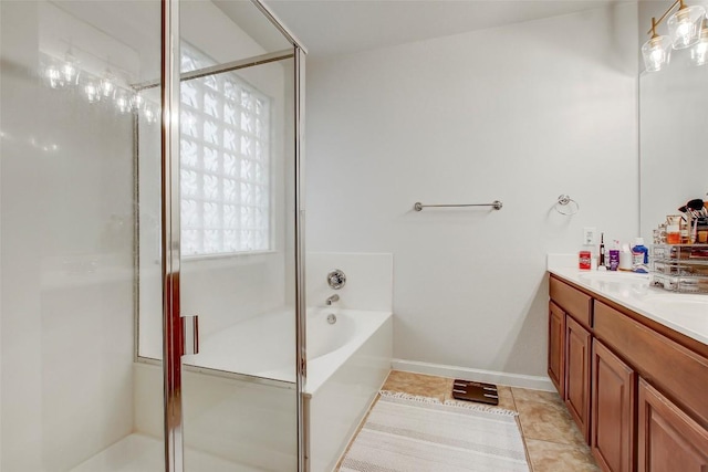 full bath featuring double vanity, a stall shower, baseboards, tile patterned flooring, and a bath