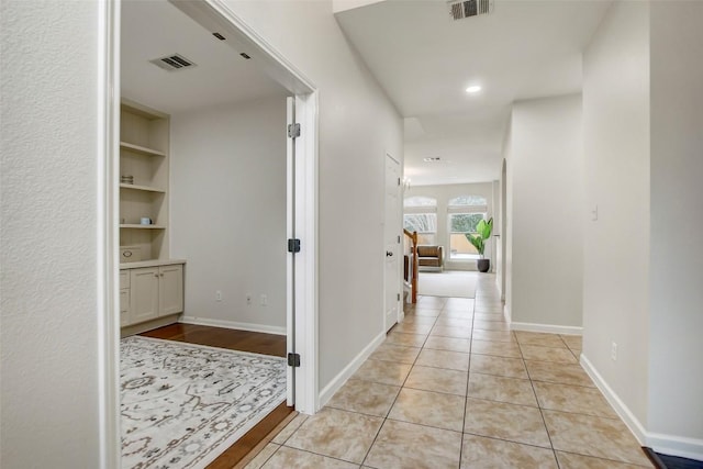18712 Deep Water Dr, Pflugerville, TX 78660 - hall with built in shelves, baseboards, recessed lighting, and light tile patterned flooring