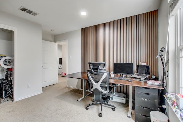 carpeted home office featuring visible vents and baseboards