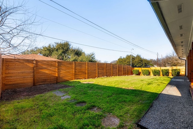 view of yard with a fenced backyard and visible vents