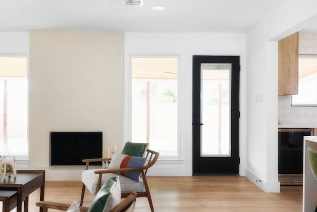 interior space featuring light wood finished floors and visible vents