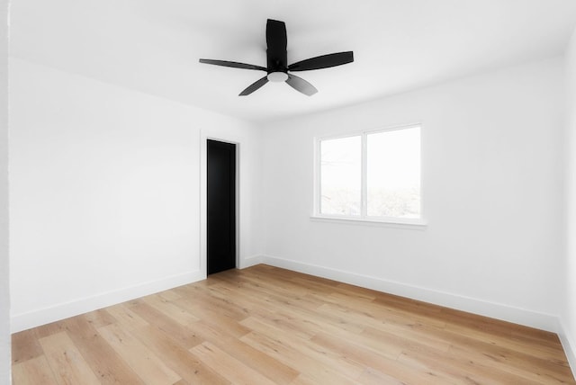 unfurnished room featuring a ceiling fan, light wood-style flooring, and baseboards