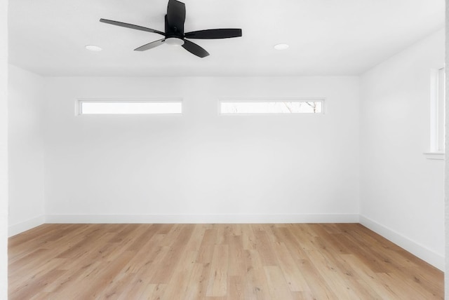 unfurnished room with light wood-style floors, baseboards, and a ceiling fan