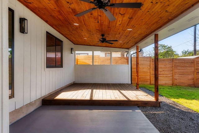 wooden terrace featuring ceiling fan and fence