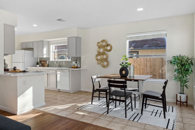 dining room with light tile patterned floors, baseboards, visible vents, and recessed lighting
