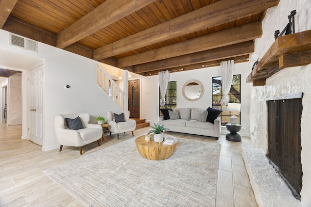 living area featuring a fireplace, visible vents, wood ceiling, beamed ceiling, and stairs