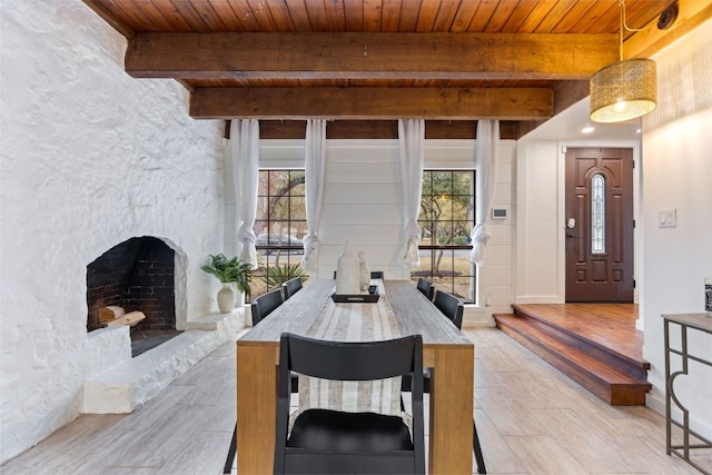 dining space featuring a wealth of natural light, beam ceiling, and wood ceiling