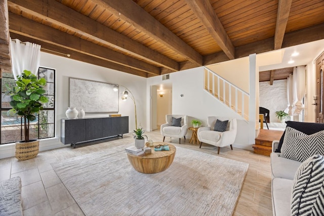 living area with wooden ceiling, stairs, visible vents, and beam ceiling