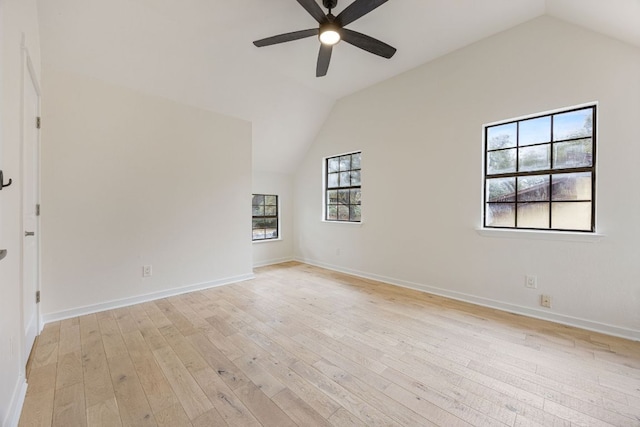 spare room featuring light wood-type flooring, baseboards, a ceiling fan, and lofted ceiling