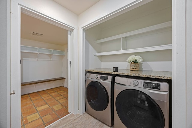 clothes washing area featuring laundry area, visible vents, and independent washer and dryer