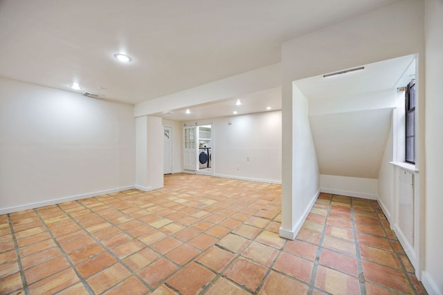 finished basement with light tile patterned floors, recessed lighting, washer / clothes dryer, visible vents, and baseboards