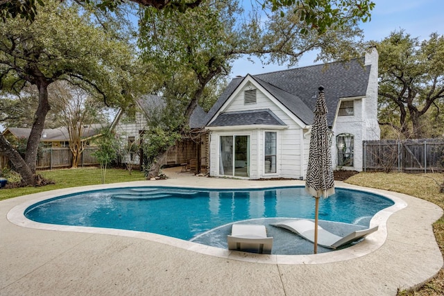 view of pool featuring a patio, a lawn, a fenced backyard, and a fenced in pool