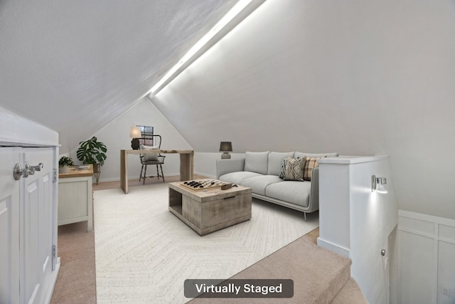 living room featuring lofted ceiling and carpet