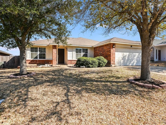 single story home with a garage, driveway, brick siding, and fence