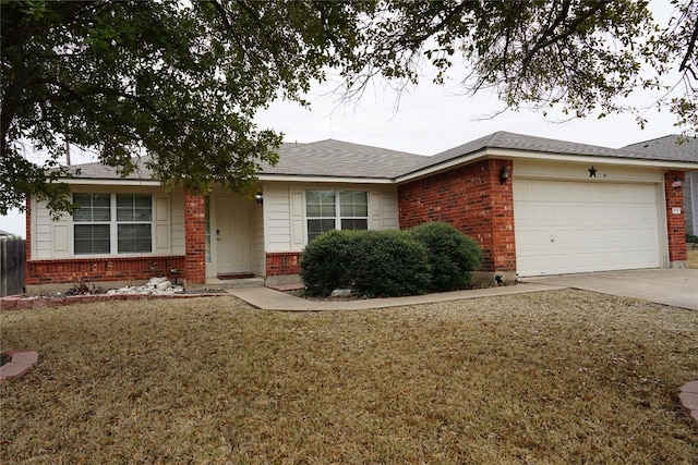 single story home with driveway, an attached garage, a front yard, and brick siding