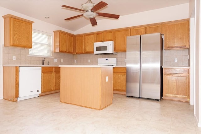 kitchen with white appliances, a ceiling fan, a center island, vaulted ceiling, and light countertops