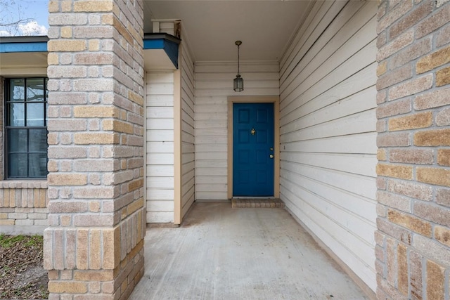 property entrance with brick siding