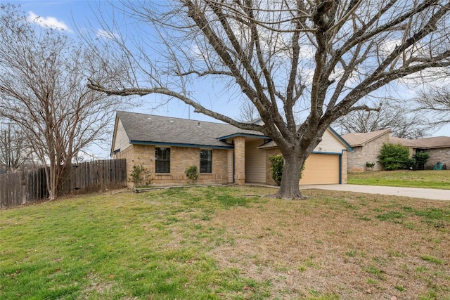 view of front of home with driveway, roof with shingles, an attached garage, fence, and a front yard