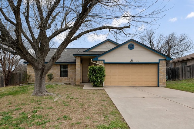 ranch-style house with a garage, fence, concrete driveway, and a front yard