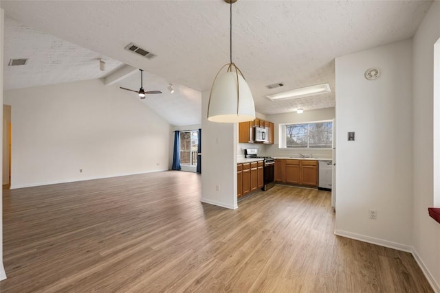 kitchen featuring light wood finished floors, visible vents, appliances with stainless steel finishes, and open floor plan