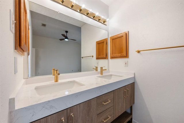 full bath with double vanity, a sink, and ceiling fan