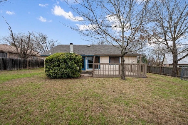 back of house featuring a fenced backyard, a wooden deck, and a yard