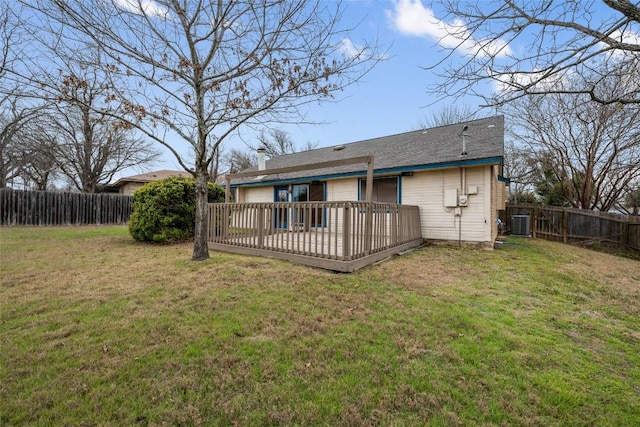 rear view of house featuring a deck, central AC unit, a lawn, and a fenced backyard