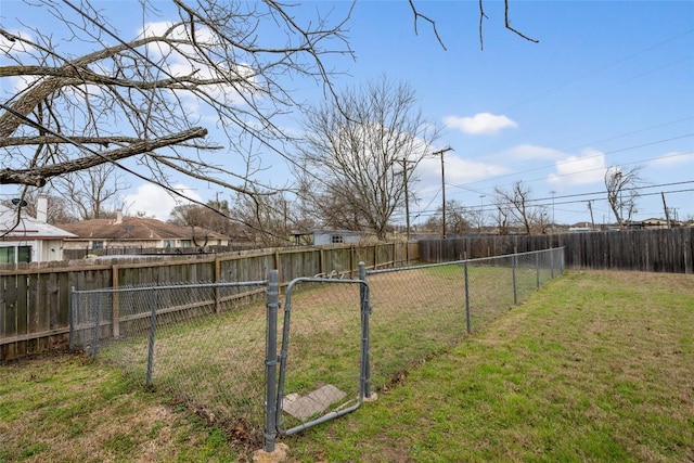 view of yard featuring a fenced backyard and a gate