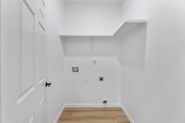 laundry room featuring gas dryer hookup, hookup for a washing machine, laundry area, light wood finished floors, and electric dryer hookup