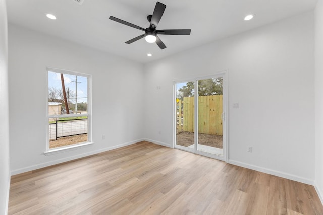 empty room with recessed lighting, ceiling fan, light wood-style flooring, and baseboards