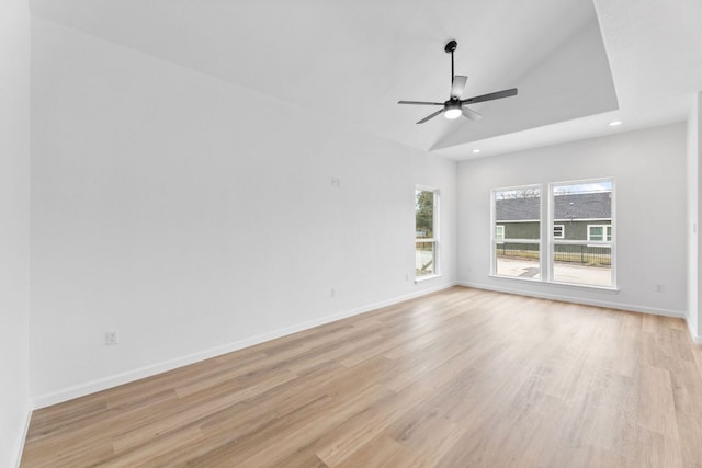 empty room with light wood-type flooring, baseboards, vaulted ceiling, and recessed lighting